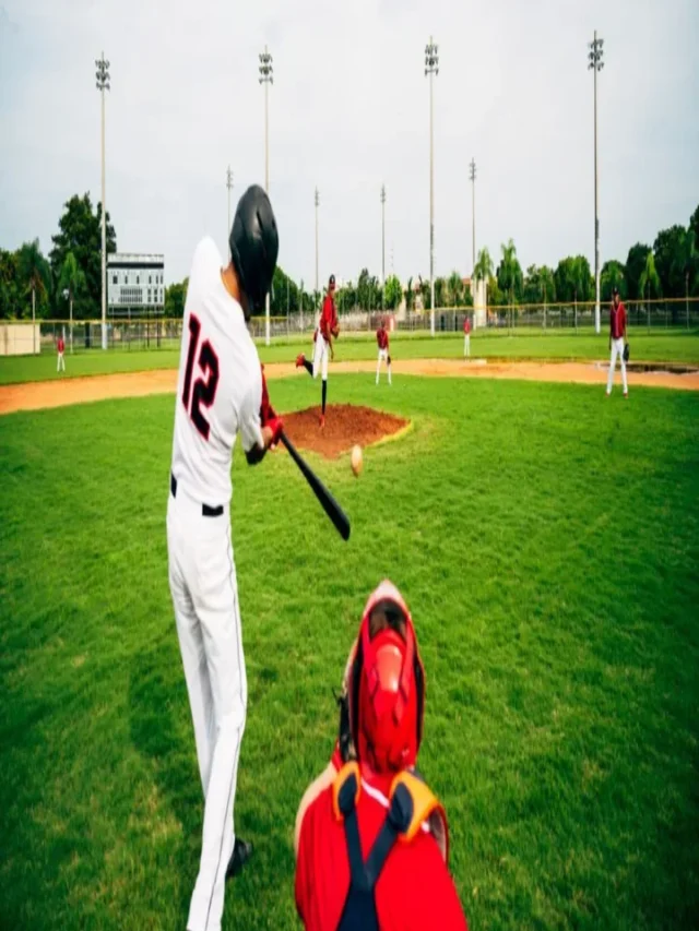 Young baseball player swinging his bat at thrown pitch